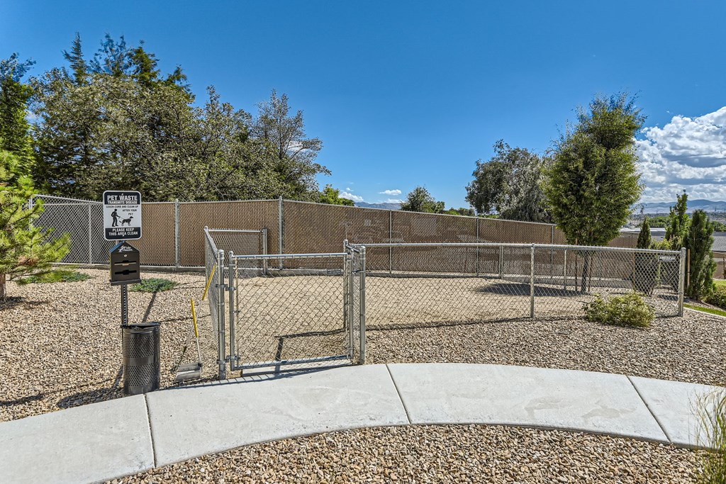 a fenced in area with a chain link fence and a parking meter