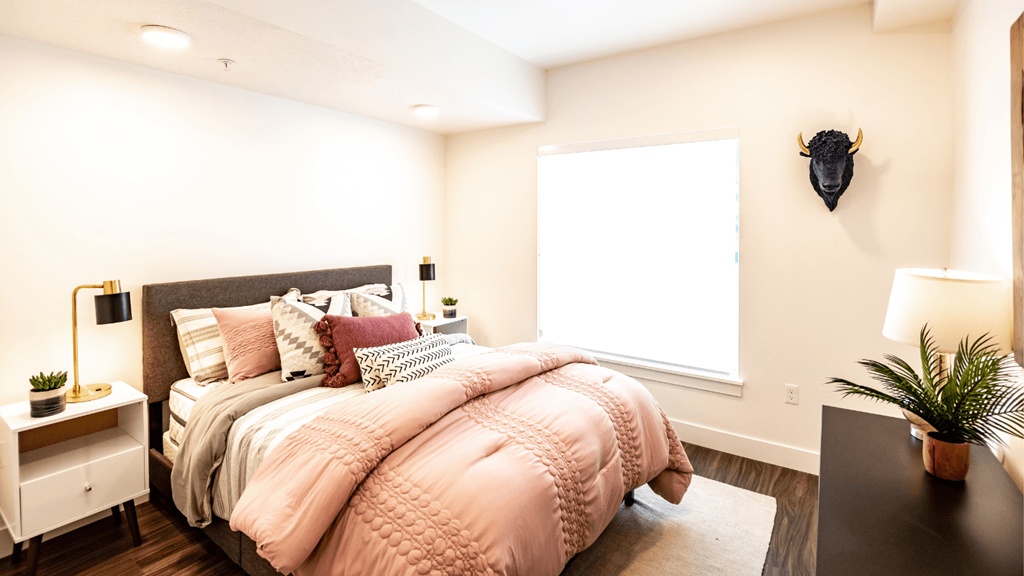 a bedroom with a large bed and a window