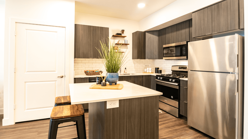 a kitchen with stainless steel appliances and a white counter top