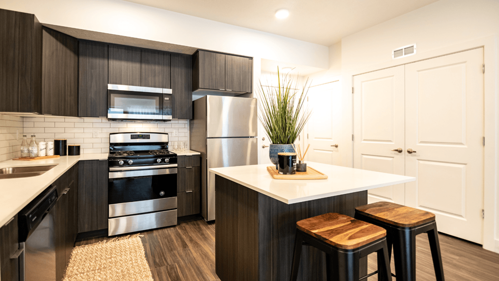 a modern kitchen with stainless steel appliances and black and white