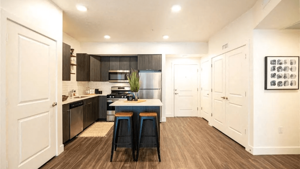 a kitchen with black and white cabinets and a counter top