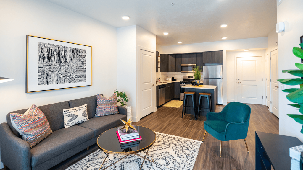 a living room and kitchen with a couch and a table