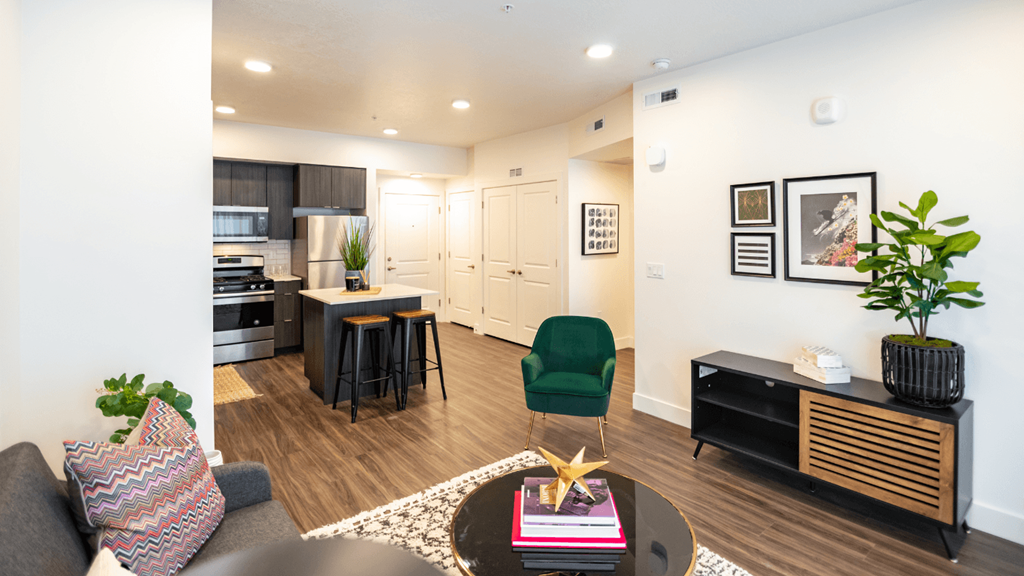 a living room and kitchen with a dining area and a table