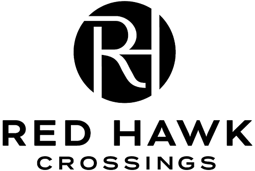 A logo with the text "RED HAWK CROSSINGS" in front of a black circle with a white letter "R" inside it.