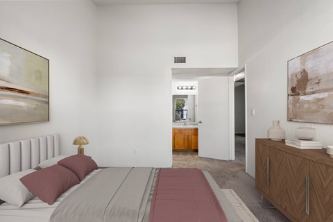 A bedroom with a large bed and a painting on the wall.