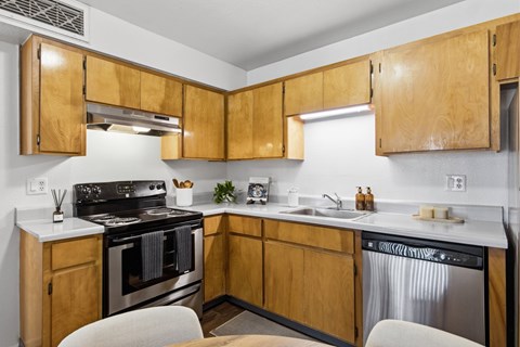 A kitchen with wooden cabinets and stainless steel appliances.