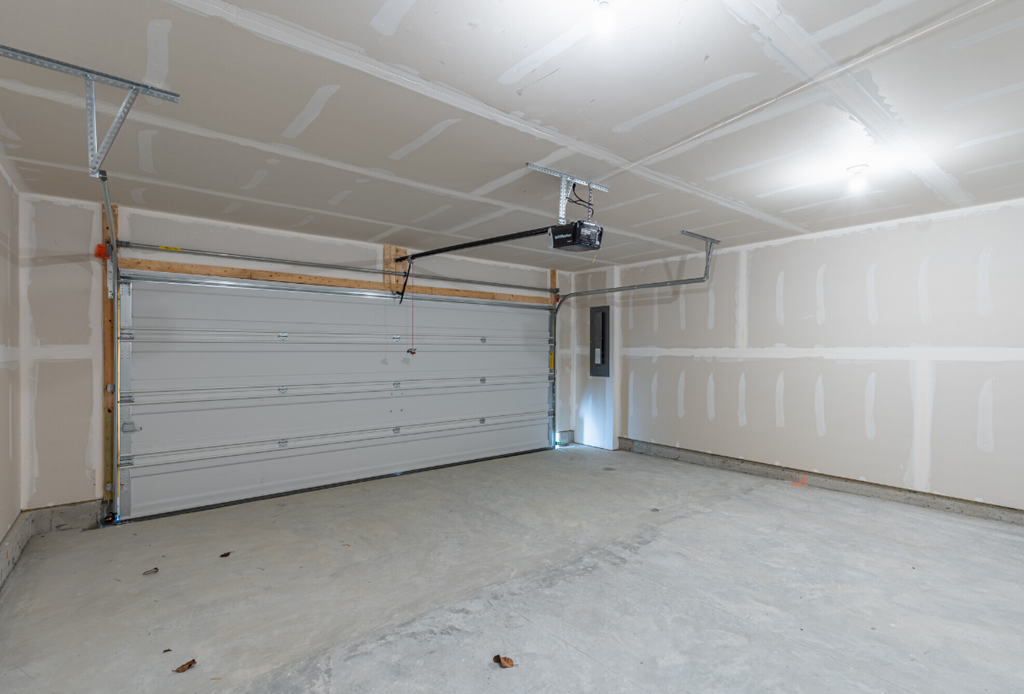 the inside of a garage with a white garage door
