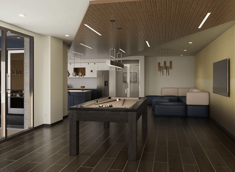 A modern kitchen with a pool table in the middle.