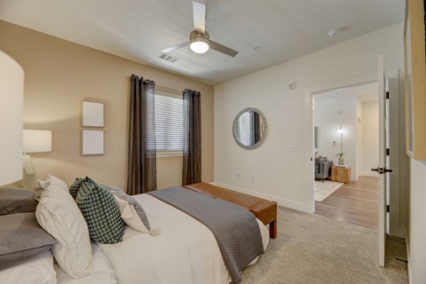 a bedroom with a large bed and a ceiling fan