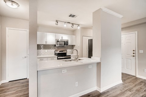 a kitchen with a counter top and a microwave