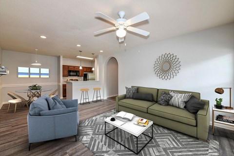 A living room with a grey couch and a white coffee table.