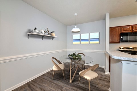 A dining area with a glass table and chairs.