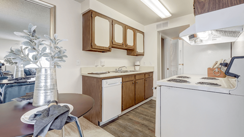 a kitchen with white appliances and wooden cabinets and a dining table