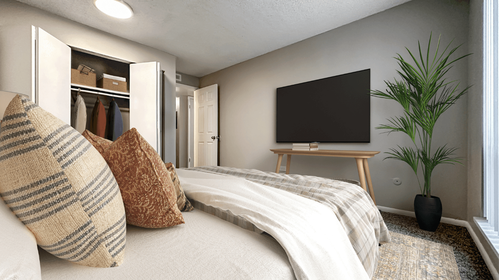 a bedroom with a bed and a tv