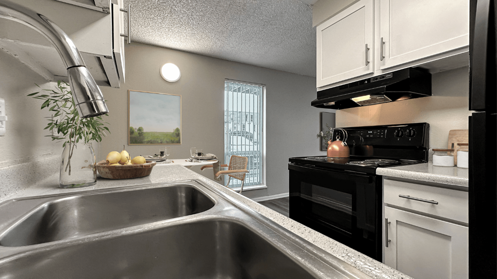 a kitchen with a sink and a stove and a window