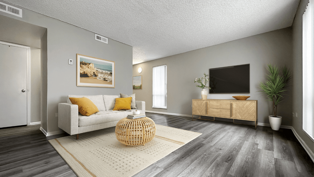 an open living room with a couch and a tv