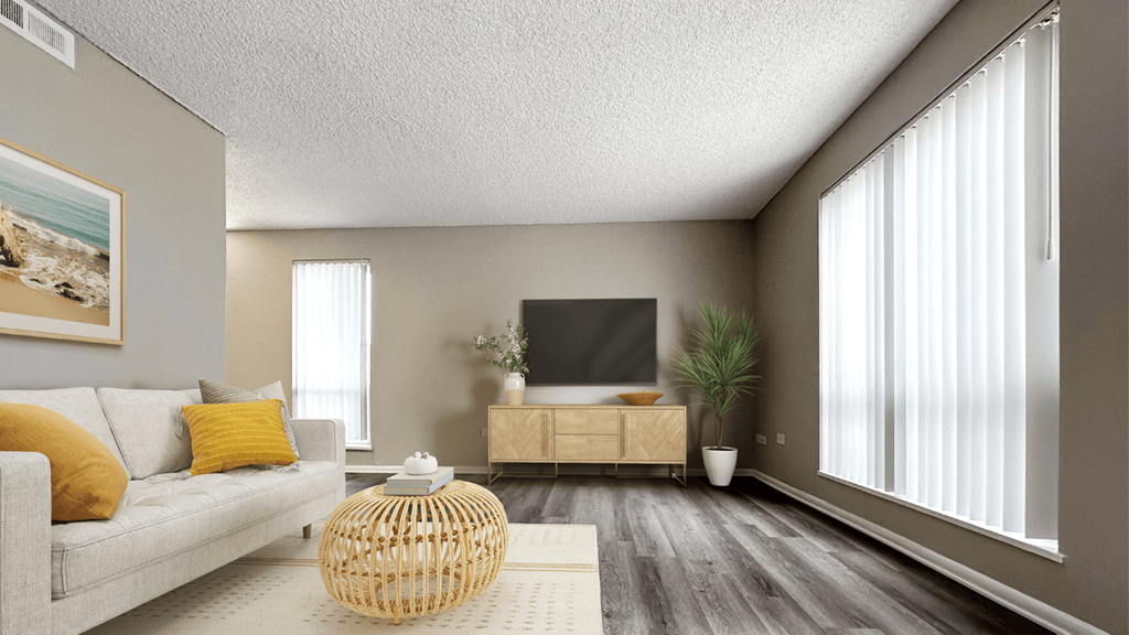 an empty living room with a couch and a tv