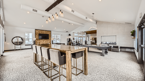 A modern dining room with a wooden table and chairs.