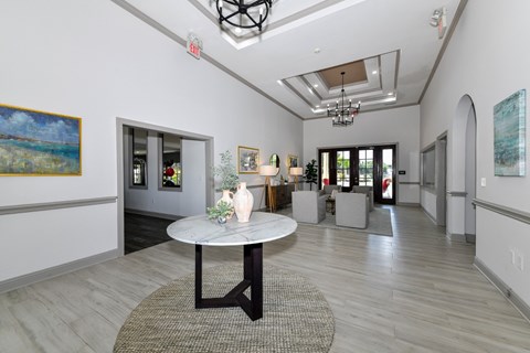 A spacious room with a round table and chairs in the center.