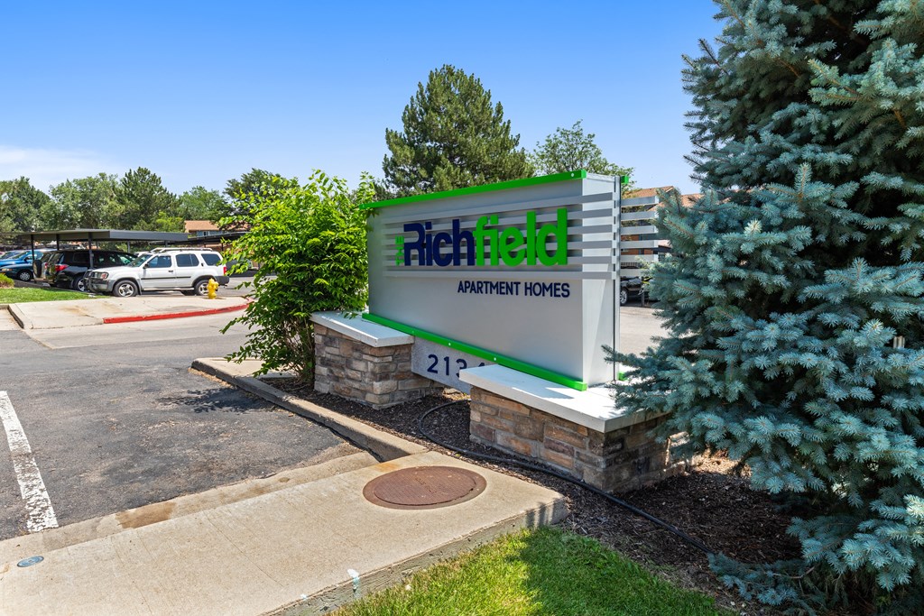 a sign for a heating and cooling company in front of a parking lot