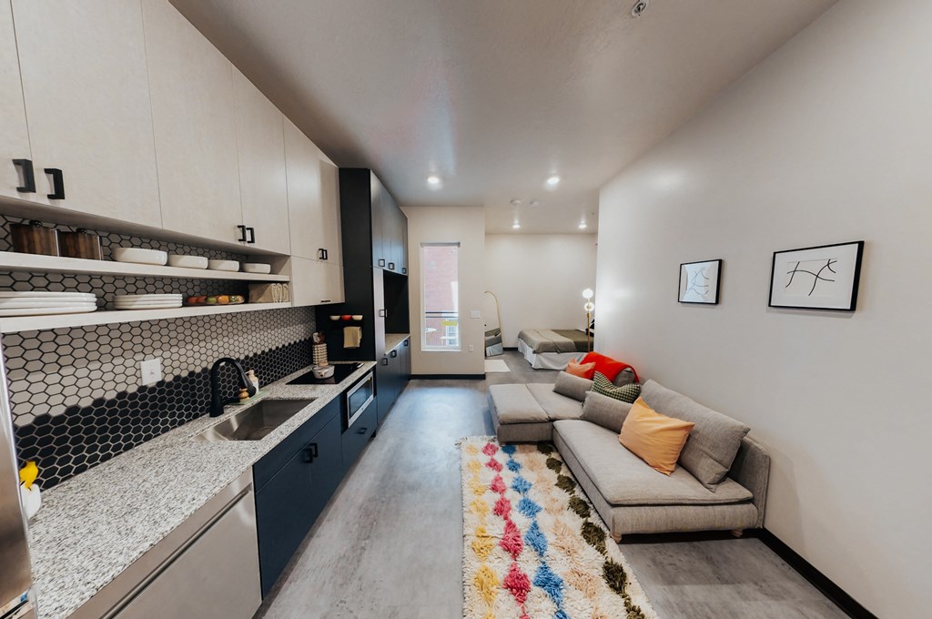 a living room with a kitchen and a couch