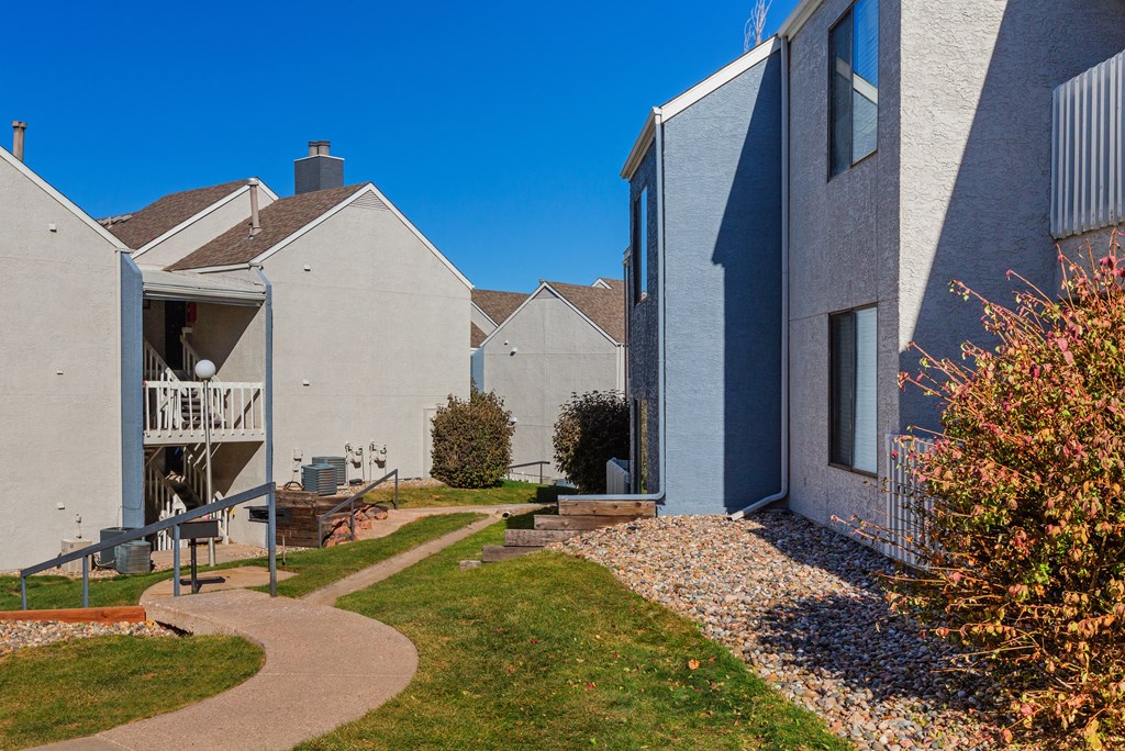 a row of houses with a walkway between them