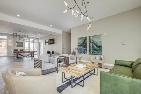 A living room with a green couch and a wooden coffee table.