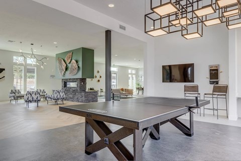 A modern dining room with a large table and chairs.