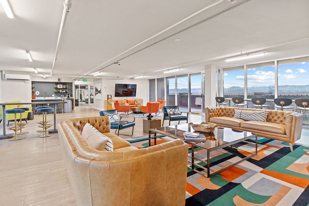 a living room with couches and chairs and a large rug