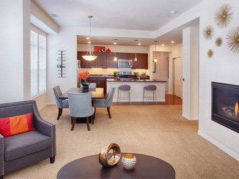 A modern living room with a grey sofa and a black coffee table.
