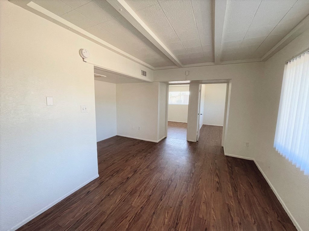 A room with wooden floors and white walls.