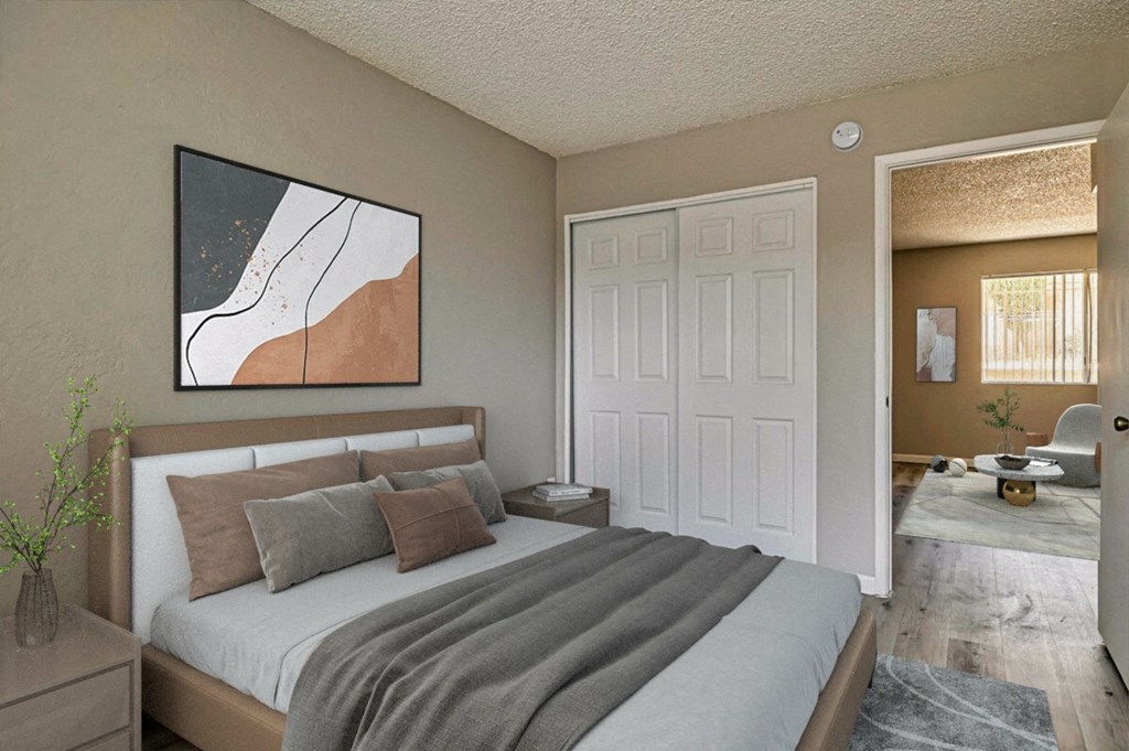 A bedroom with a bed, a nightstand, and a painting on the wall.