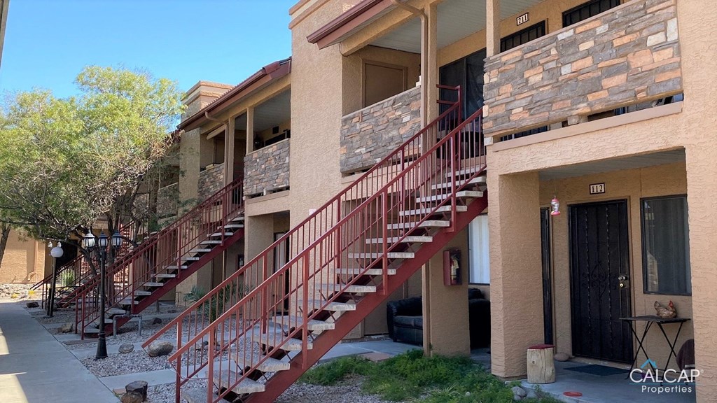 A building with a red staircase in front of it.