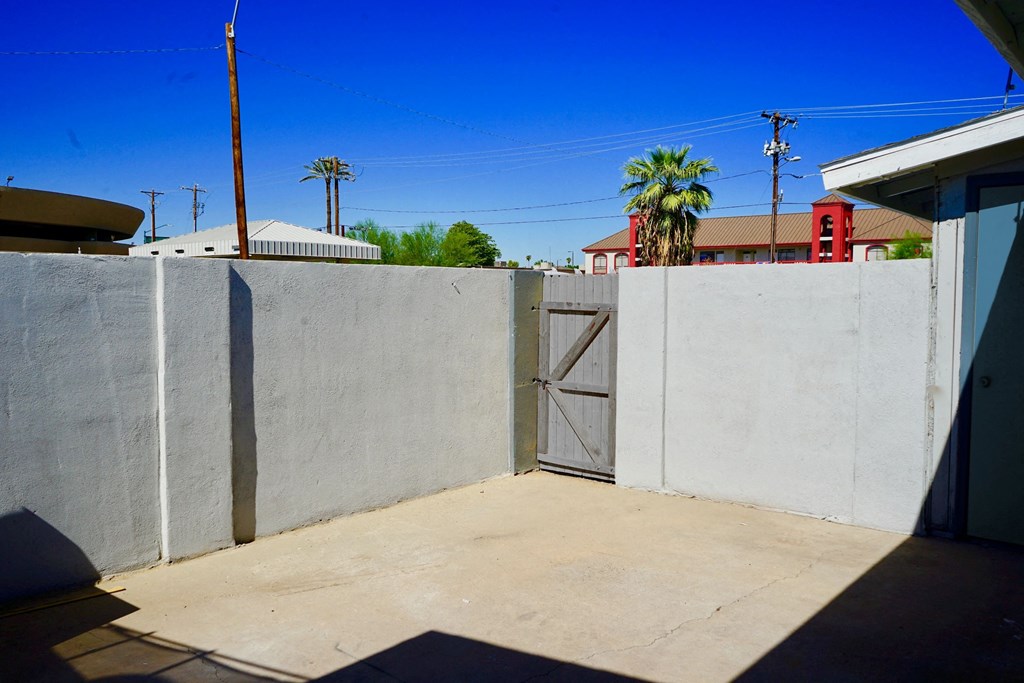 A concrete wall with a door in the middle.