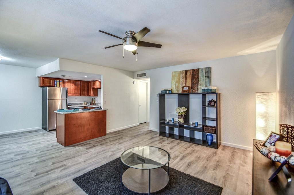A living room with a refrigerator, a sofa, and a coffee table.