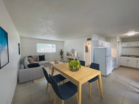 A dining room with a table and chairs.