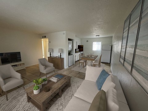 A living room with a white couch and a wooden coffee table.