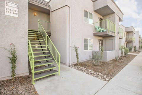 A building with a green staircase outside.