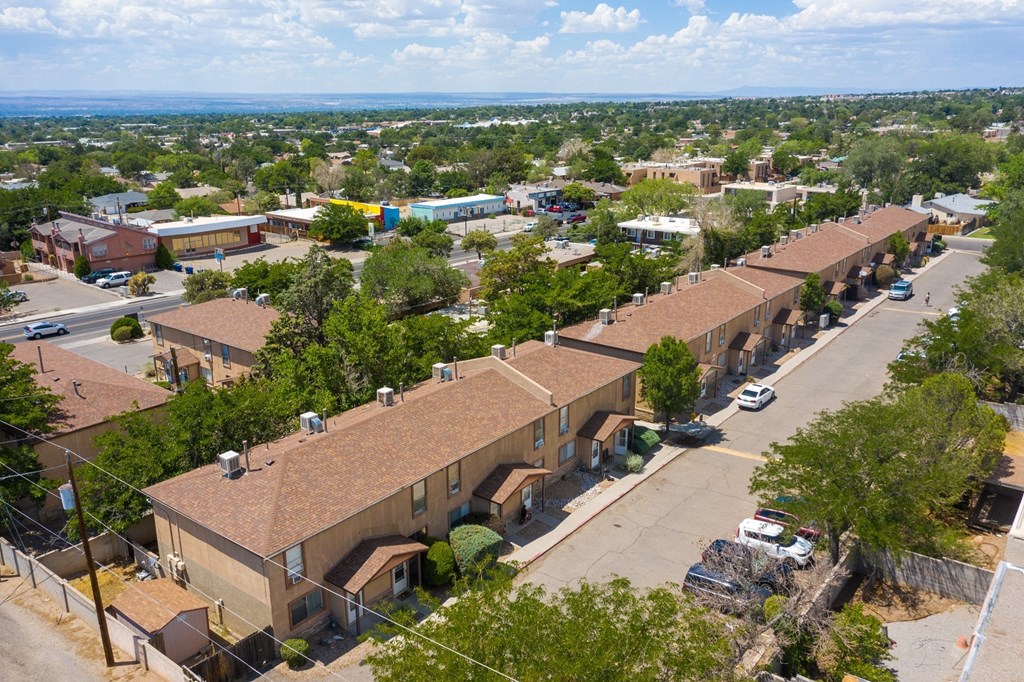 A view of a residential area with houses and cars.