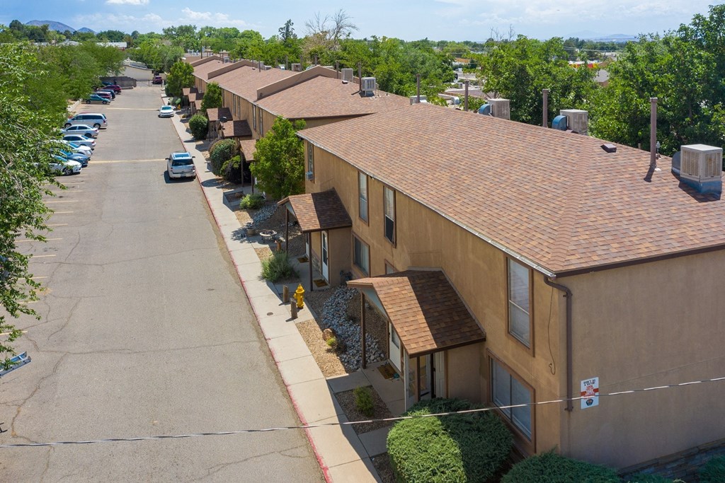 A row of houses with a street in between.