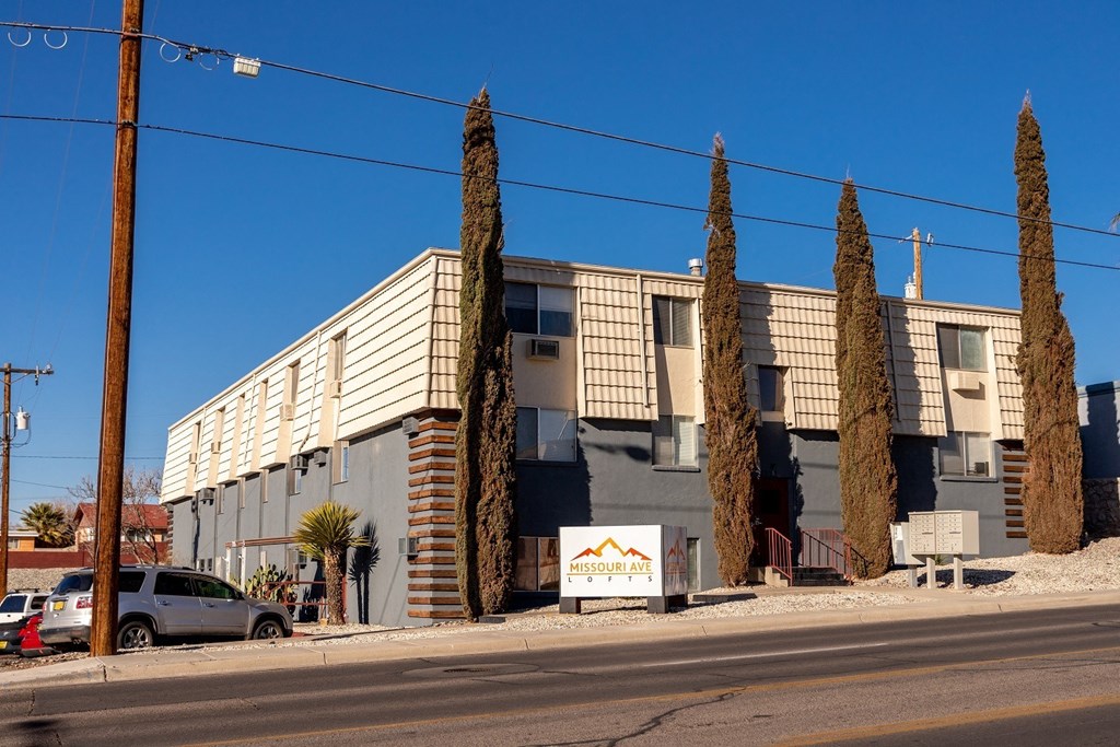 A building with a sign that says "MessouraVille" in front of it.