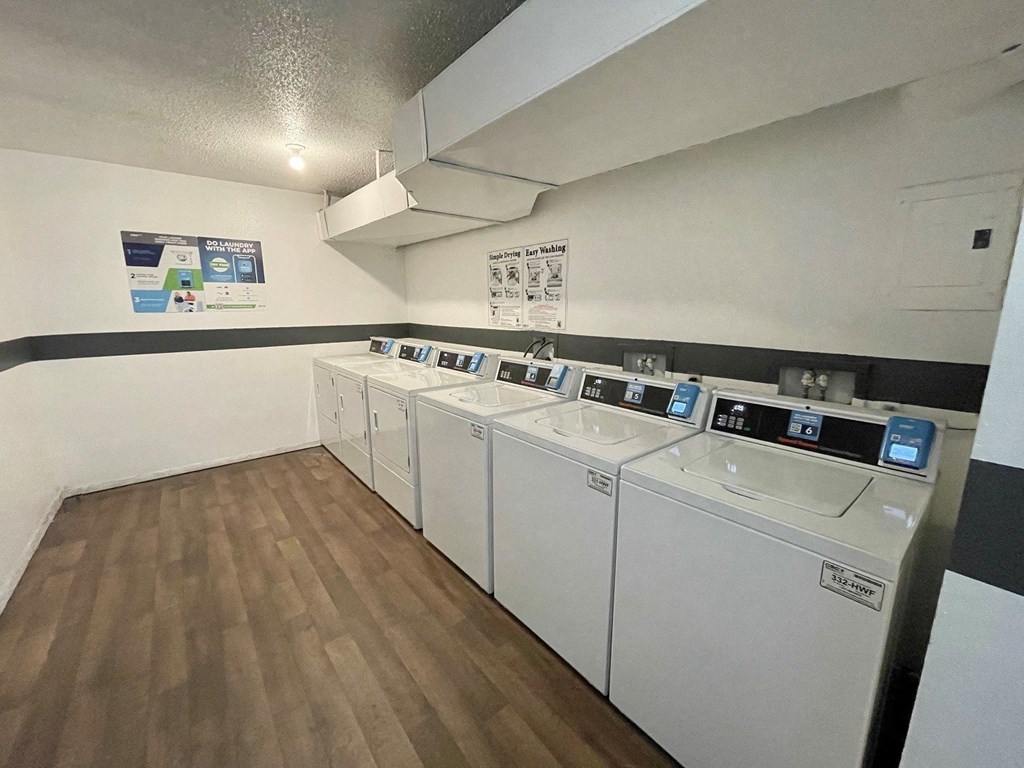 A row of washing machines in a laundromat.