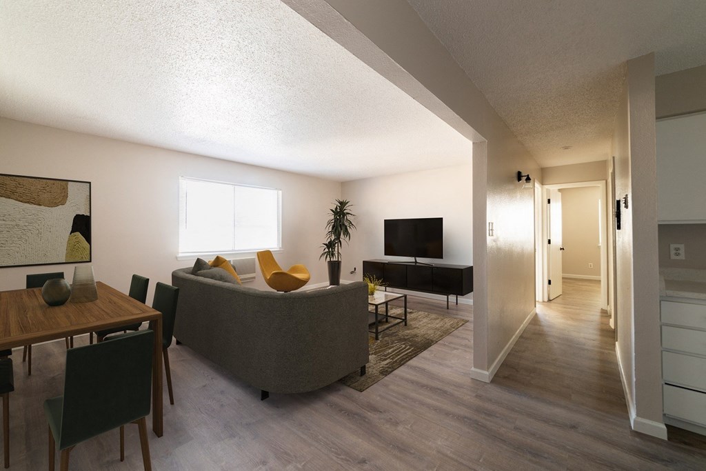 A living room with a grey couch and a wooden table.