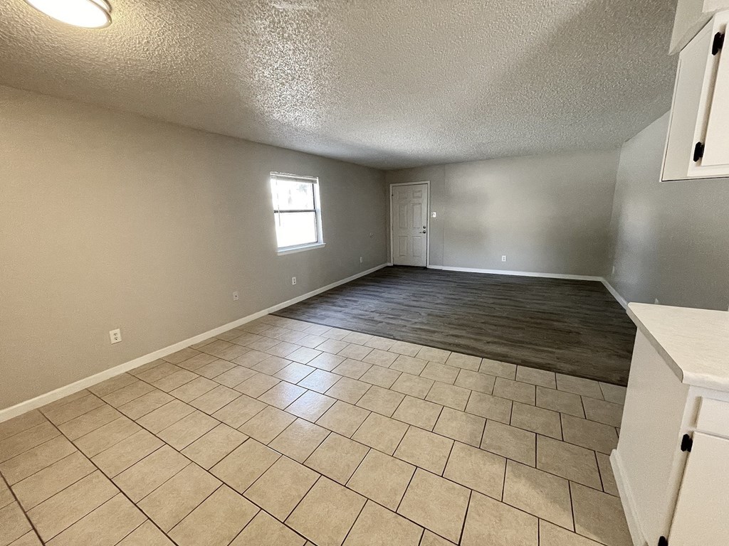 A room with a tiled floor and a window.