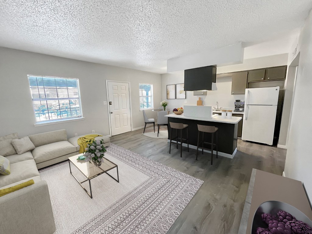 A modern kitchen with a dining area and a living room.