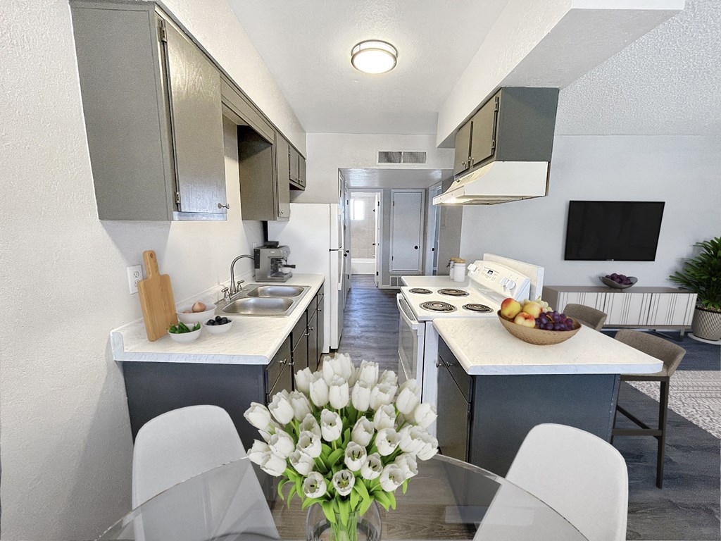 A modern kitchen with white cabinets and a central island.