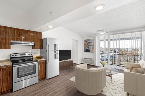 A modern kitchen with a stove top oven and a refrigerator.