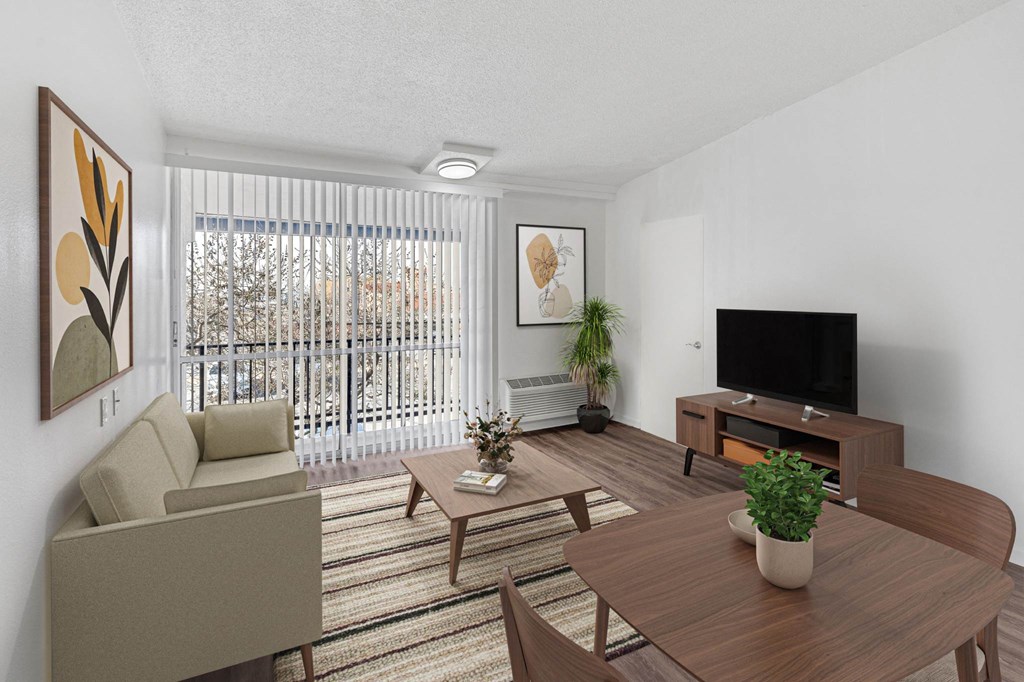 A living room with a couch, chair, and television.