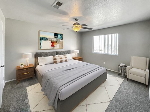 A bedroom with a large bed and a ceiling fan.