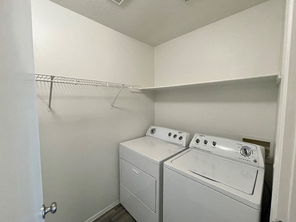 A small laundry room with a washer and dryer.
